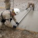 Seabee works on concrete at Forward Operating Base Pasab