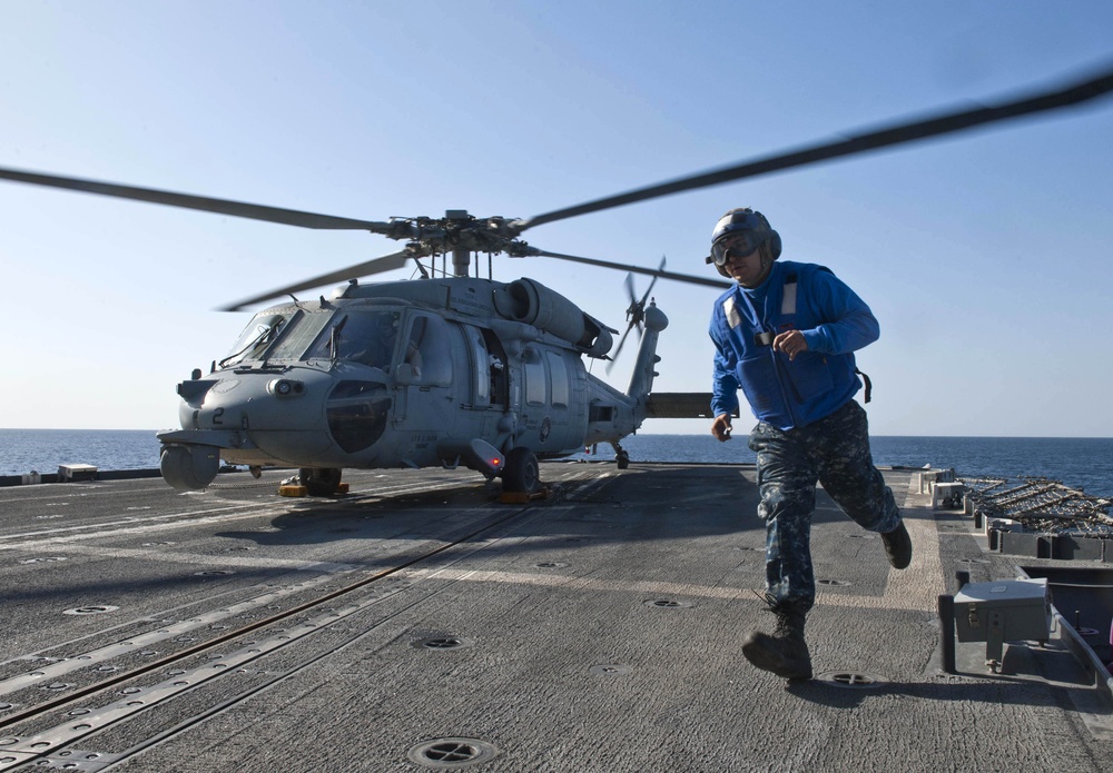 Sailor secures helicopter aboard USS Cape St. George