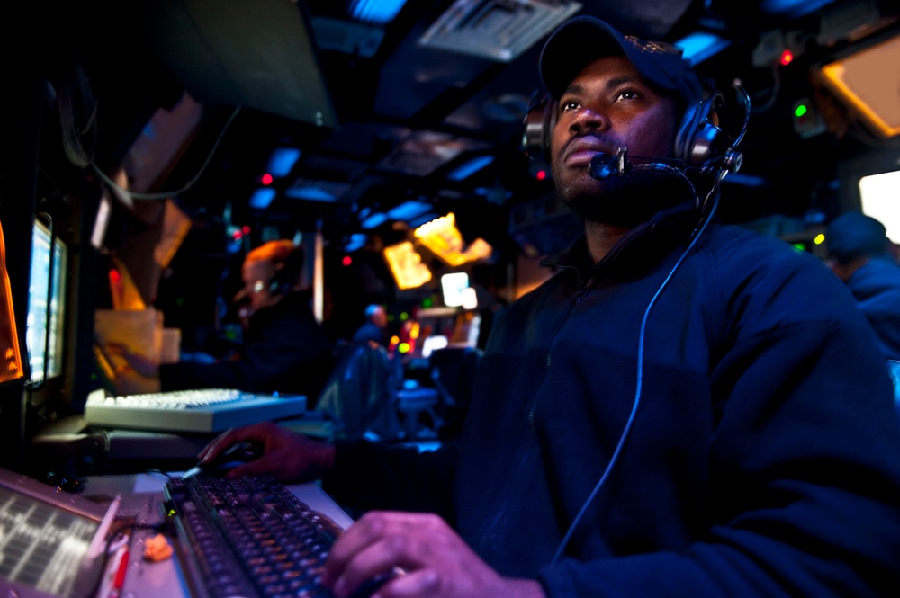 USS Cape St. George sailor mans controls