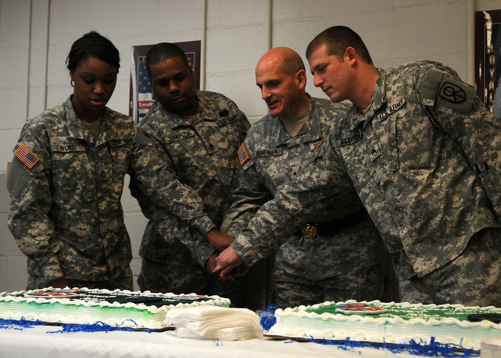 451st Soldiers cut cake to celebrate new patch