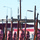 A group of military recruits with shaved heads stand in formation holding rifles with bayonets fixed, pointed upward. The scene appears to be a drill or parade ceremony conducted outdoors in a military installation or urban area. The recruits are uniformly dressed and positioned in disciplined rows.