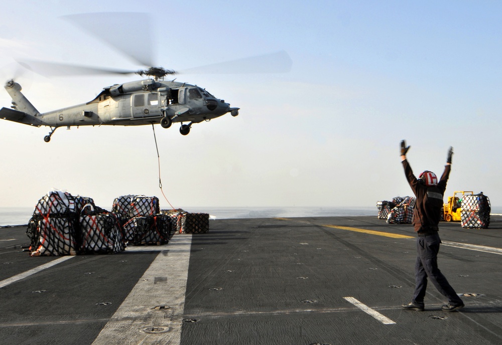 Sailor directs MH-60S Sea Hawk on USS Abraham Lincoln's flight deck