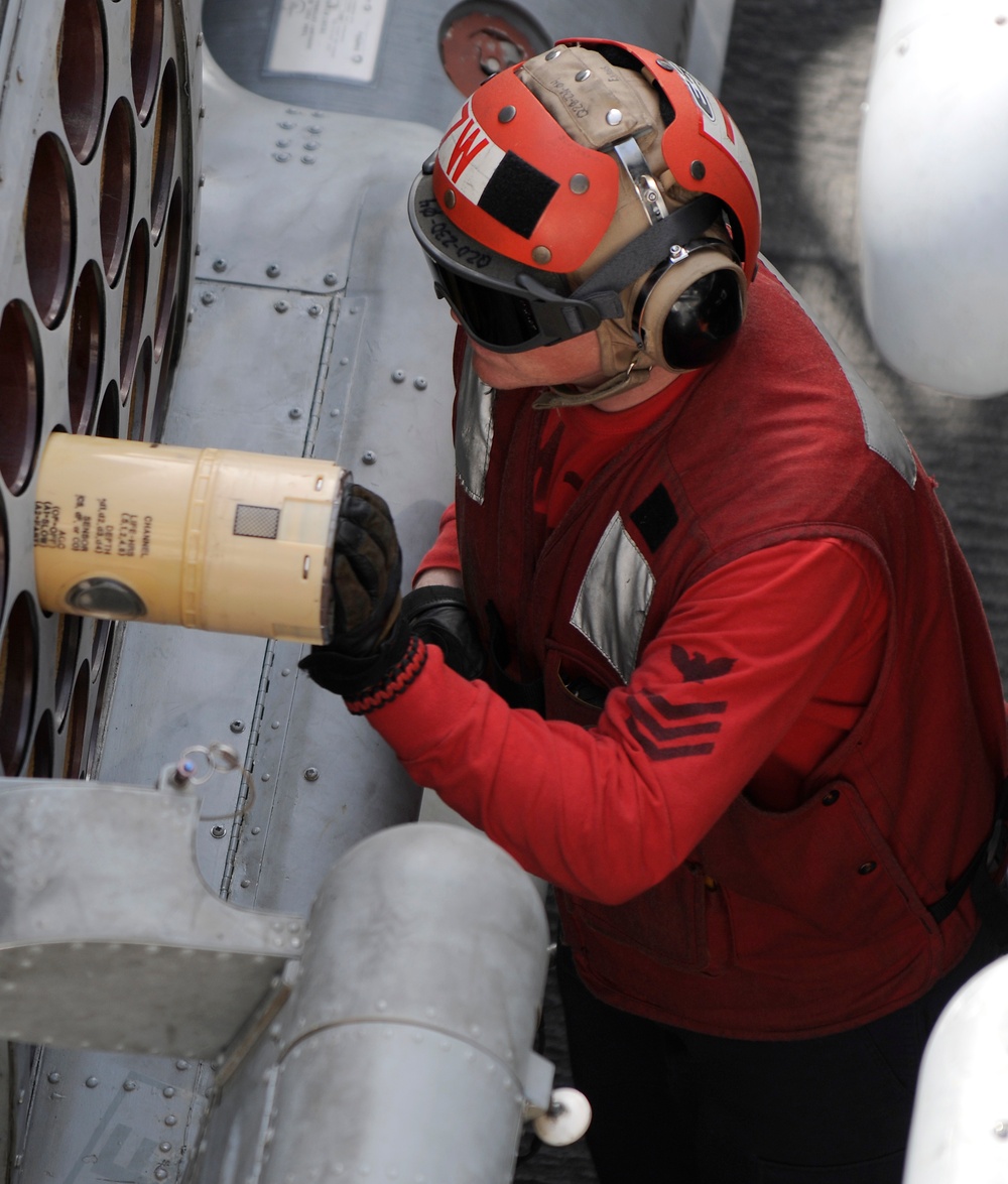 Loading ordnance into an MH-60S Sea Hawk helicopter