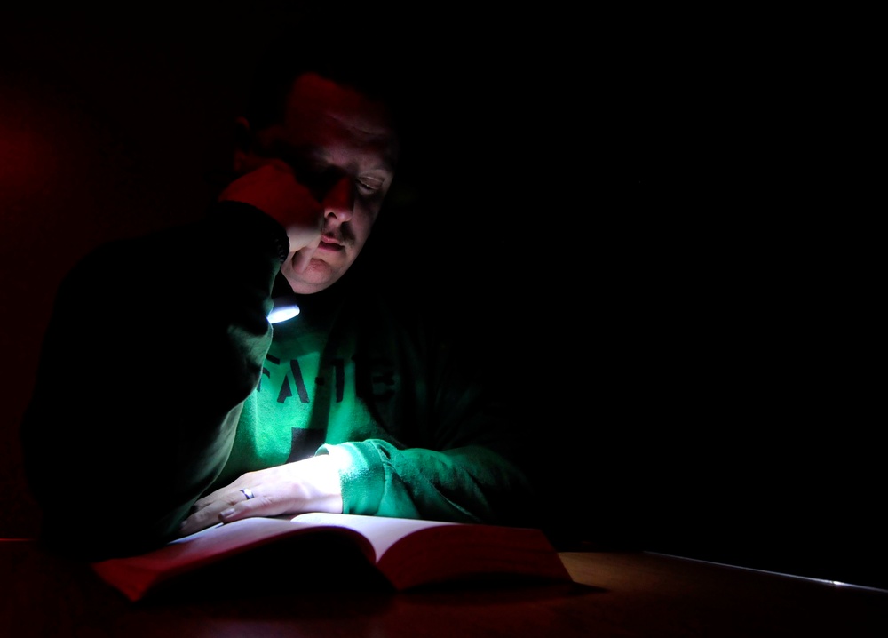 USS Carl Vinson sailor reads crew berthing