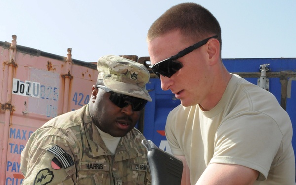 Staff Sgt. Lukeldic Harris and Spc. Tyler Clark conducting customs inspection for their upcoming redeployment.