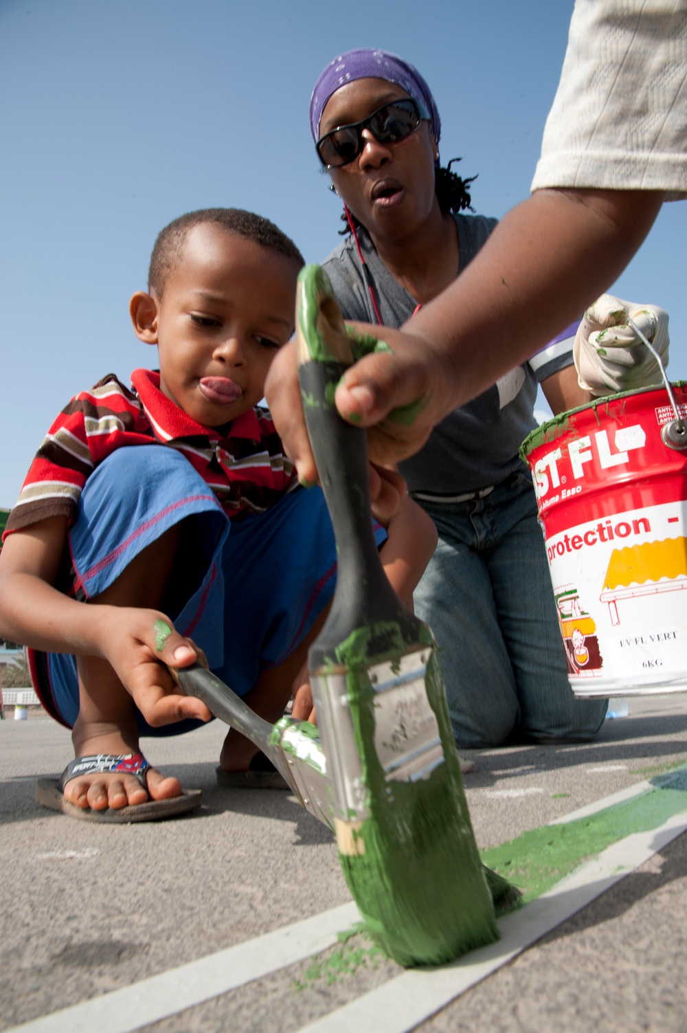 Ras Dika's basketball court receives a face-lift from US service members