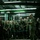 From cold to freezing, Marines head to the Arctic Circle A senior military officer in camouflage uniform addresses a large formation of armed soldiers inside an industrial or warehouse-type facility. The troops are standing in a semicircular formation, most carrying rifles, attentively listening to the briefing. The setting appears to be a pre-mission or operational briefing conducted indoors under fluorescent lighting.