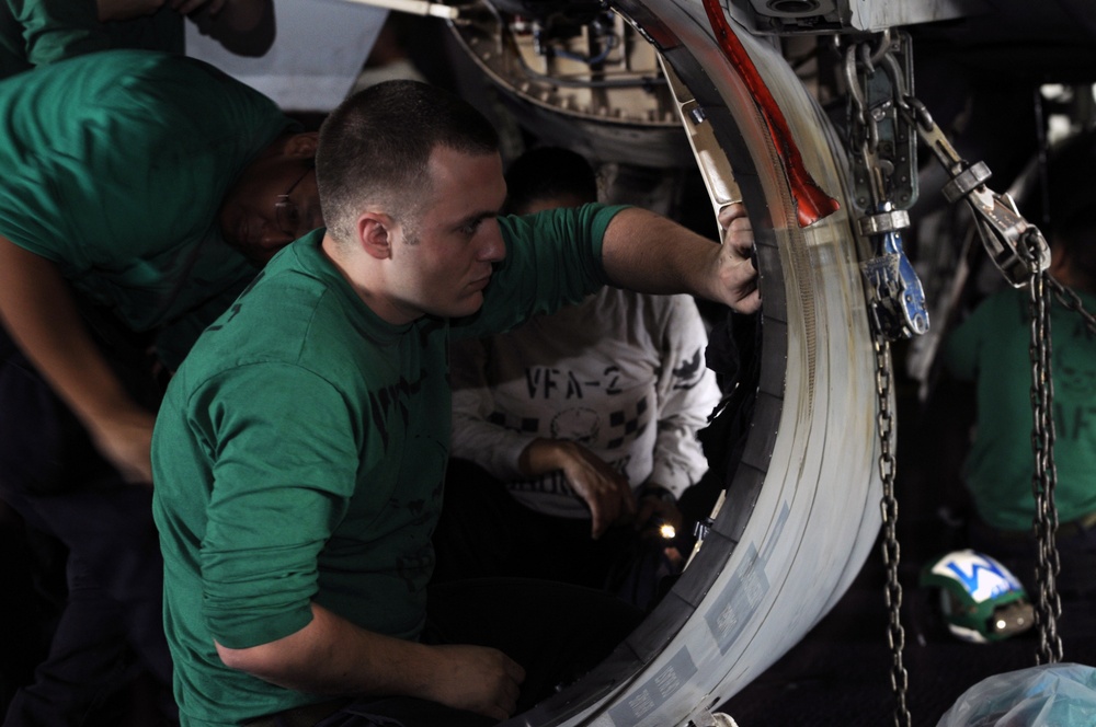 USS Abraham Lincoln sailor cleans engine cap