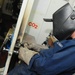 USS Kearsarge sailor repairs door