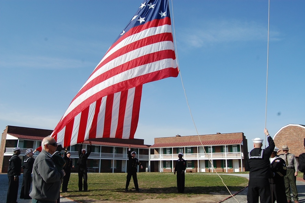 USS Fort McHenry sailors raise flag