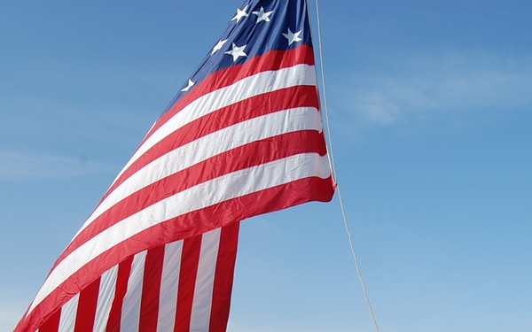 USS Fort McHenry sailors raise flag