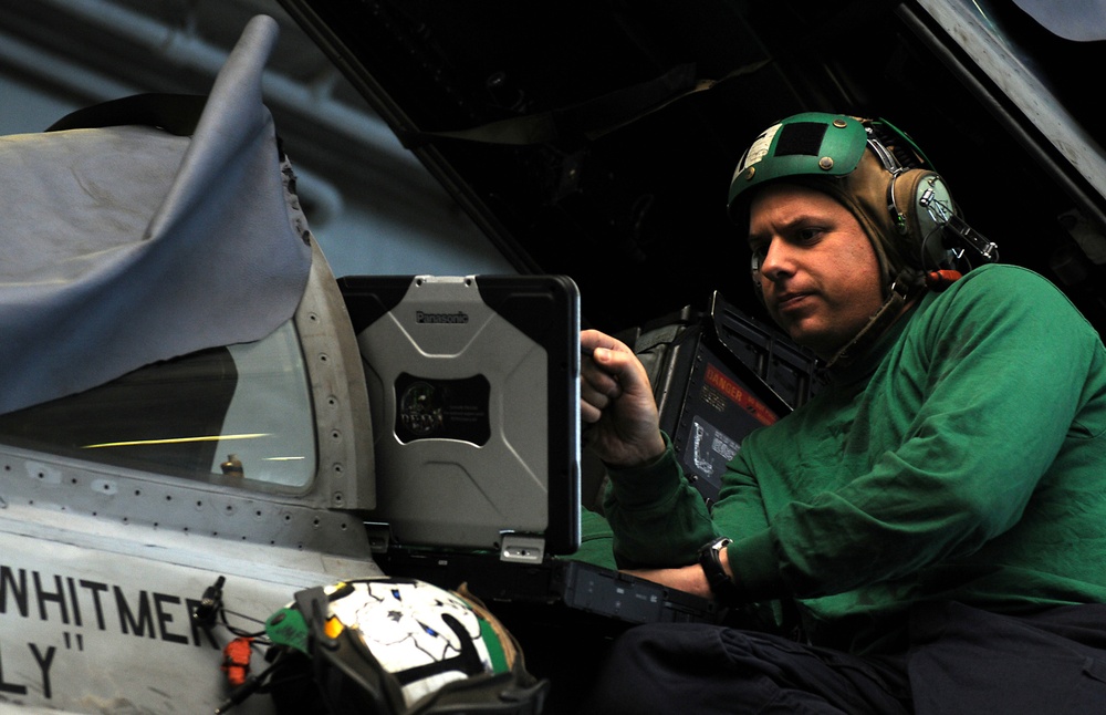 USS Abraham Lincoln sailor at work on F/A-18C Hornet