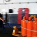 USS George H.W. Bush sailor transports bottles