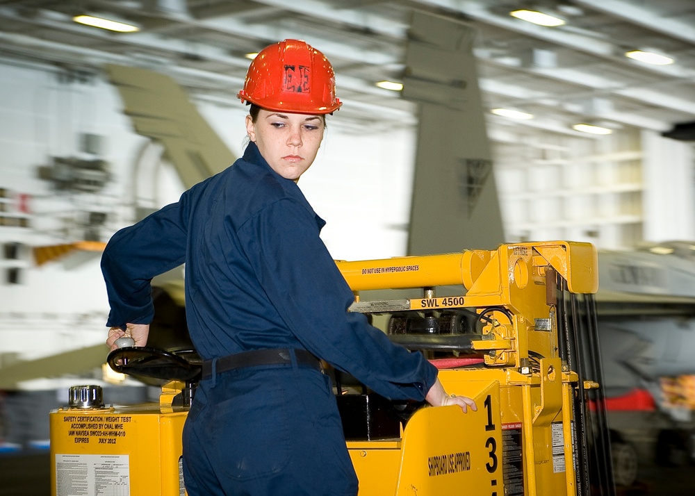 USS George H.W. Bush sailor operates forklift