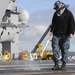 USS Nimitz sailor cleans the flight deck