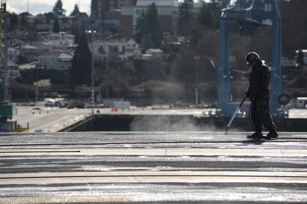 USS Nimitz sailor cleans the flight deck