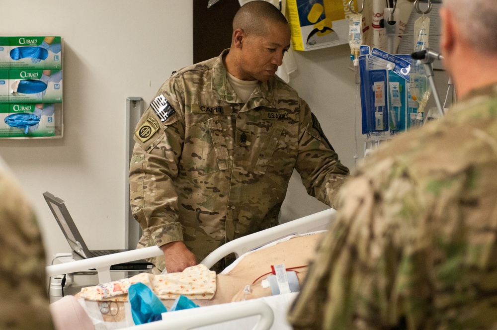 CSM Capel with soldier in hospital