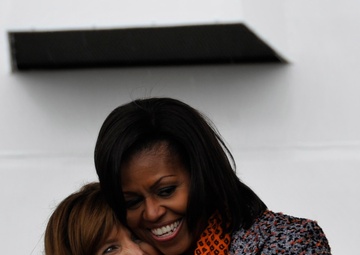 First Lady Michelle Obama congratulates Melinda Cook, the grandniece of US Coast Guard Capt. Dorothy Stratton during the commissioning ceremony of the Cutter Stratton