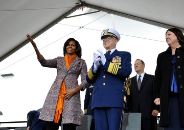 First Lady Michelle Obama and Coast Guard Commandant Adm. Bob Papp applaud during the Coast Guard Cutter Stratton's commissioning
