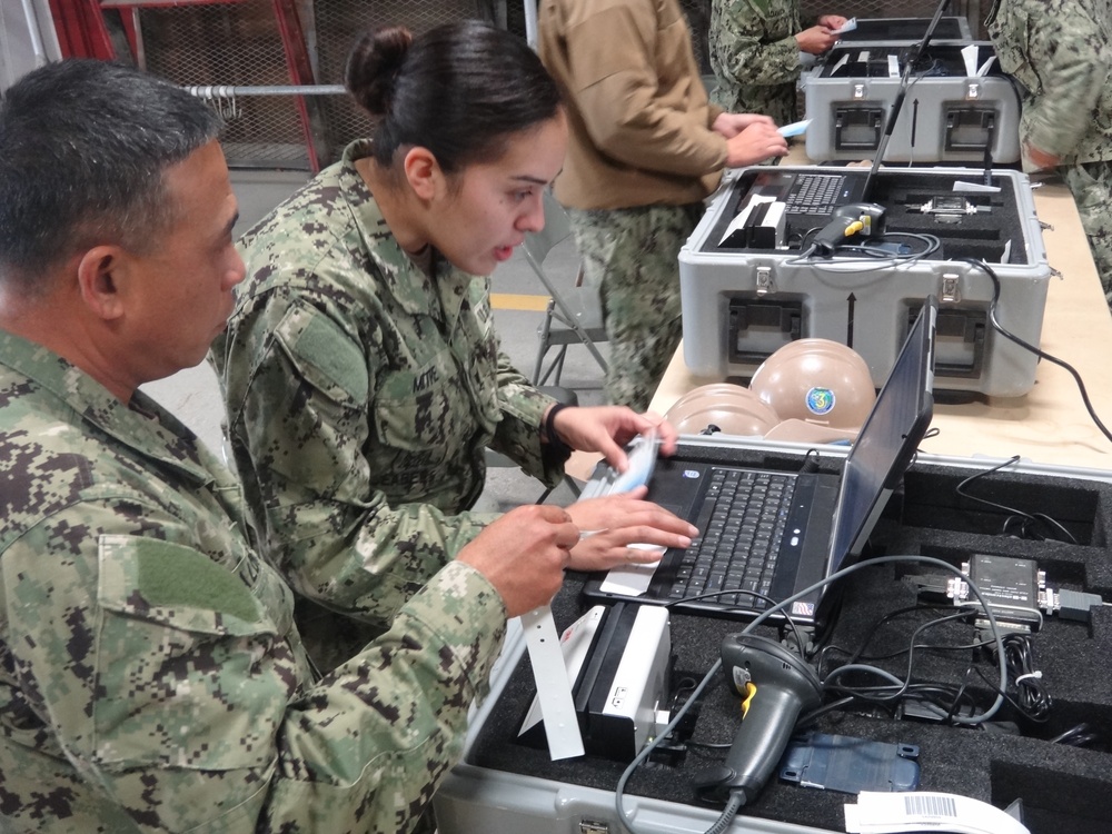 Seabees operate passport scanner during ECC drill