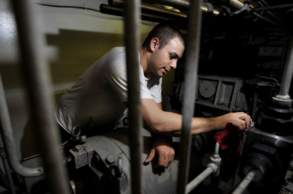 USS Carl Vinson sailor cleans engine