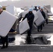 USS Ronald Reagan sailors move mattresses