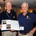 Retired USS Dwight D. Eisenhower officers hold cruise book