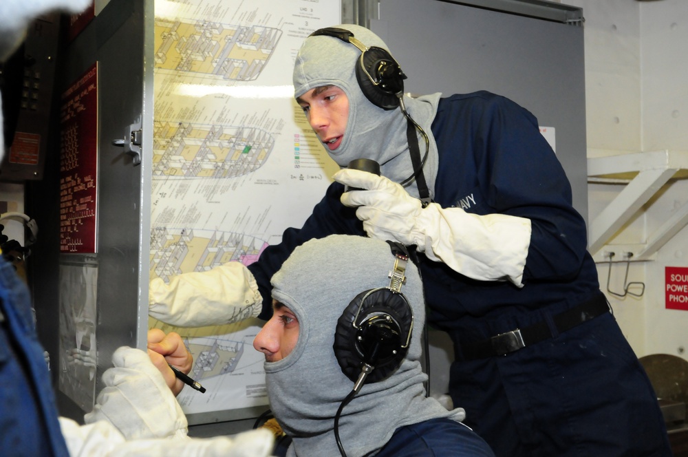 USS Kearsarge sailors update plotting board