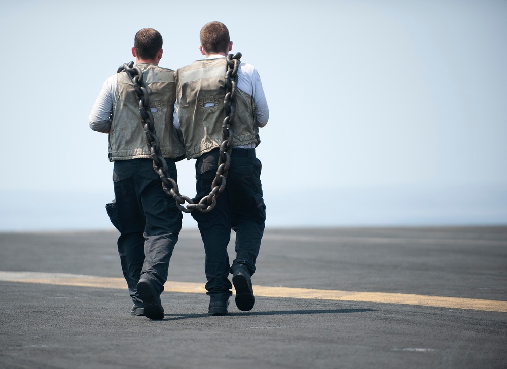 USS Carl Vinson sailors carry a chain