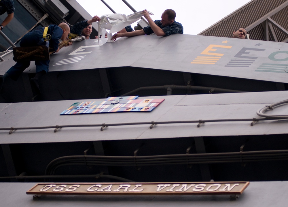 USS Carl Vinson sailors remove stencil