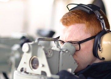 USS John C. Stenns sailor uses alidade