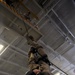 USS Abraham Lincoln sailor rappels in hangar bay