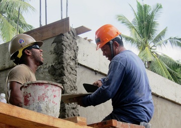 Smiling ear to ear, Philippine and U.S. military members bond during civic outreach project