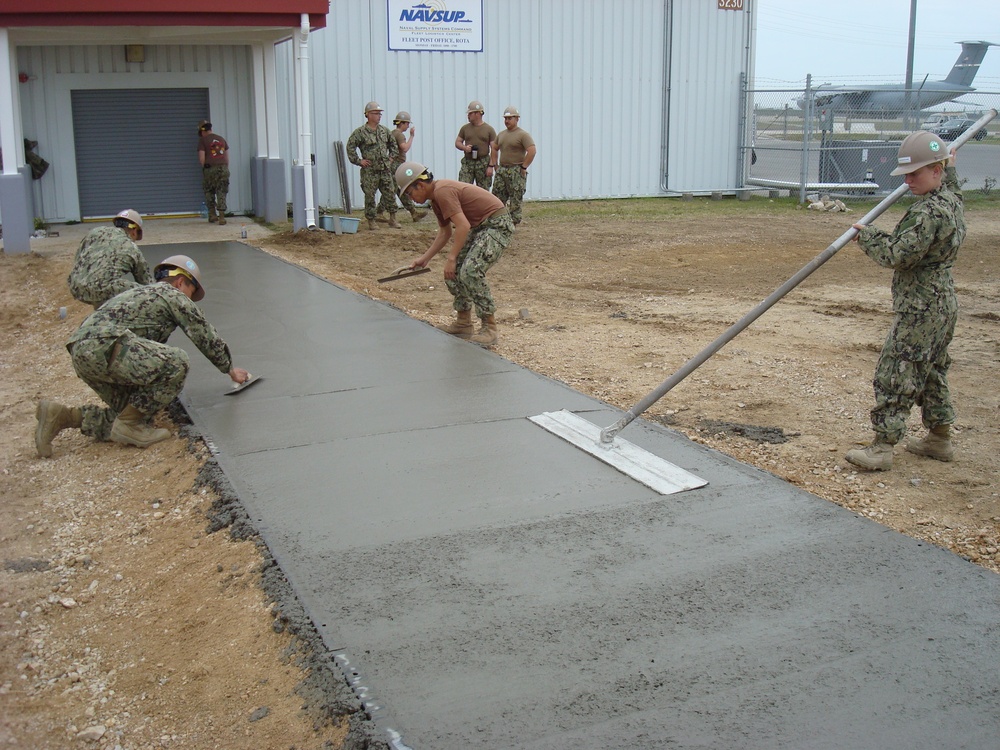 Squad of seabees place concrete