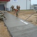 Squad of seabees place concrete