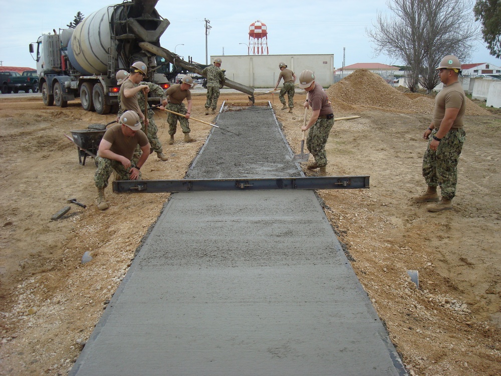 Seabees build sidewalk in Spain