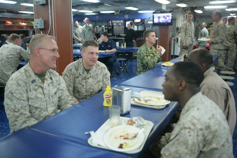 Commanding general and senior enlisted leader from 4th Marine Air Wing chat with Marines and sailors aboard the Iwo Jima during African Lion 2012