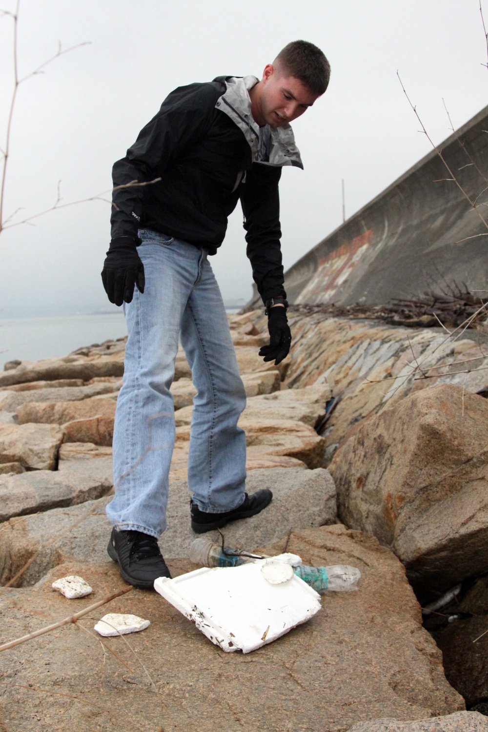 Vounteers take out trash during Earth Day sea wall cleanup
