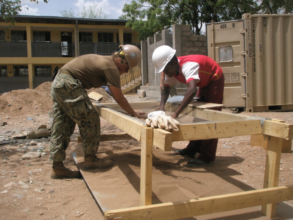 Seabee and Africans working on a project