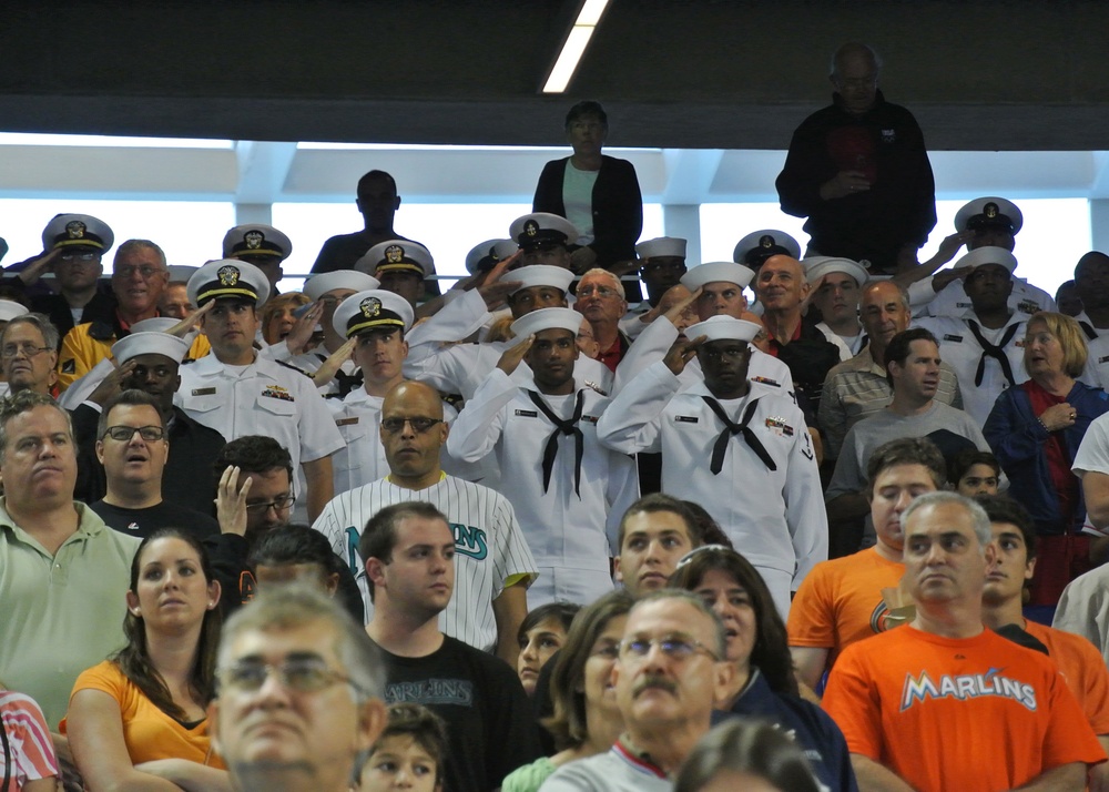 Sailors salute during Miami baseball game