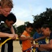 Blue Ridge sailors play games and music with Cambodian children
