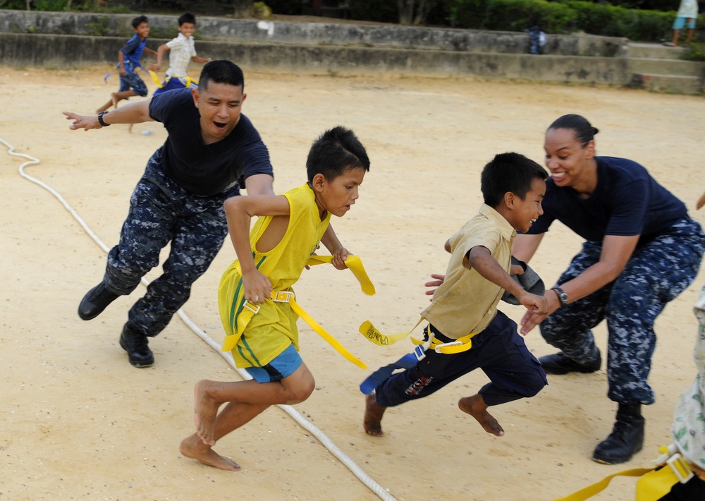 Blue Ridge sailors play games and music with Cambodian children