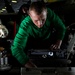 Performing maintenance on an F/A-18E Super Hornet