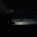 Indiana National Guard Spc. Seth Walker, silhouetted by a distant lightning strike