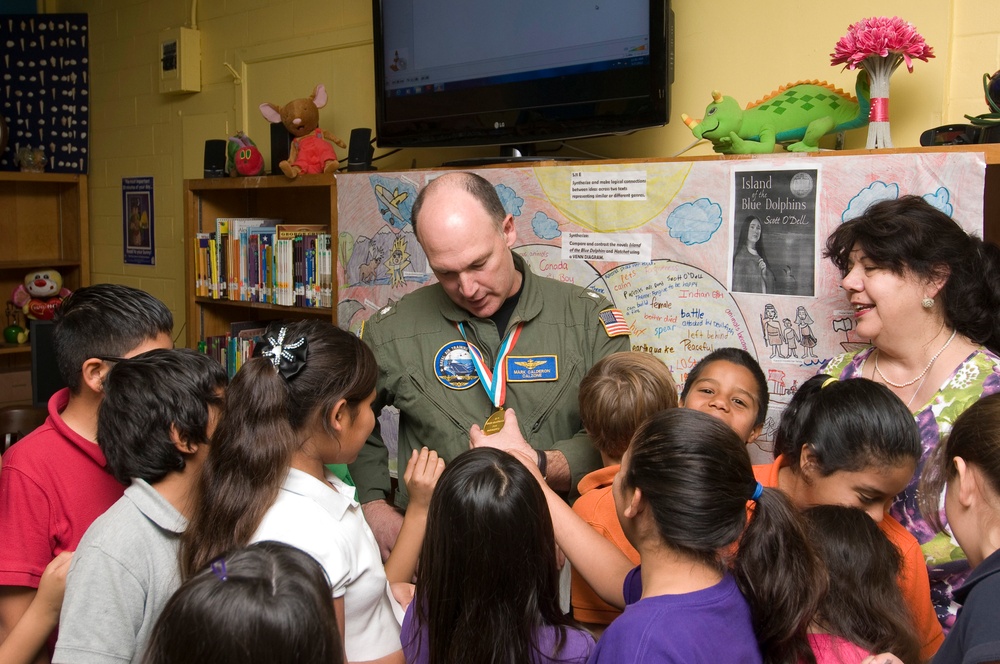 Mark Calderon shows students his gold medal