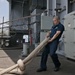 USS Dwight D. Eisenhower sailor lays out mooring lines