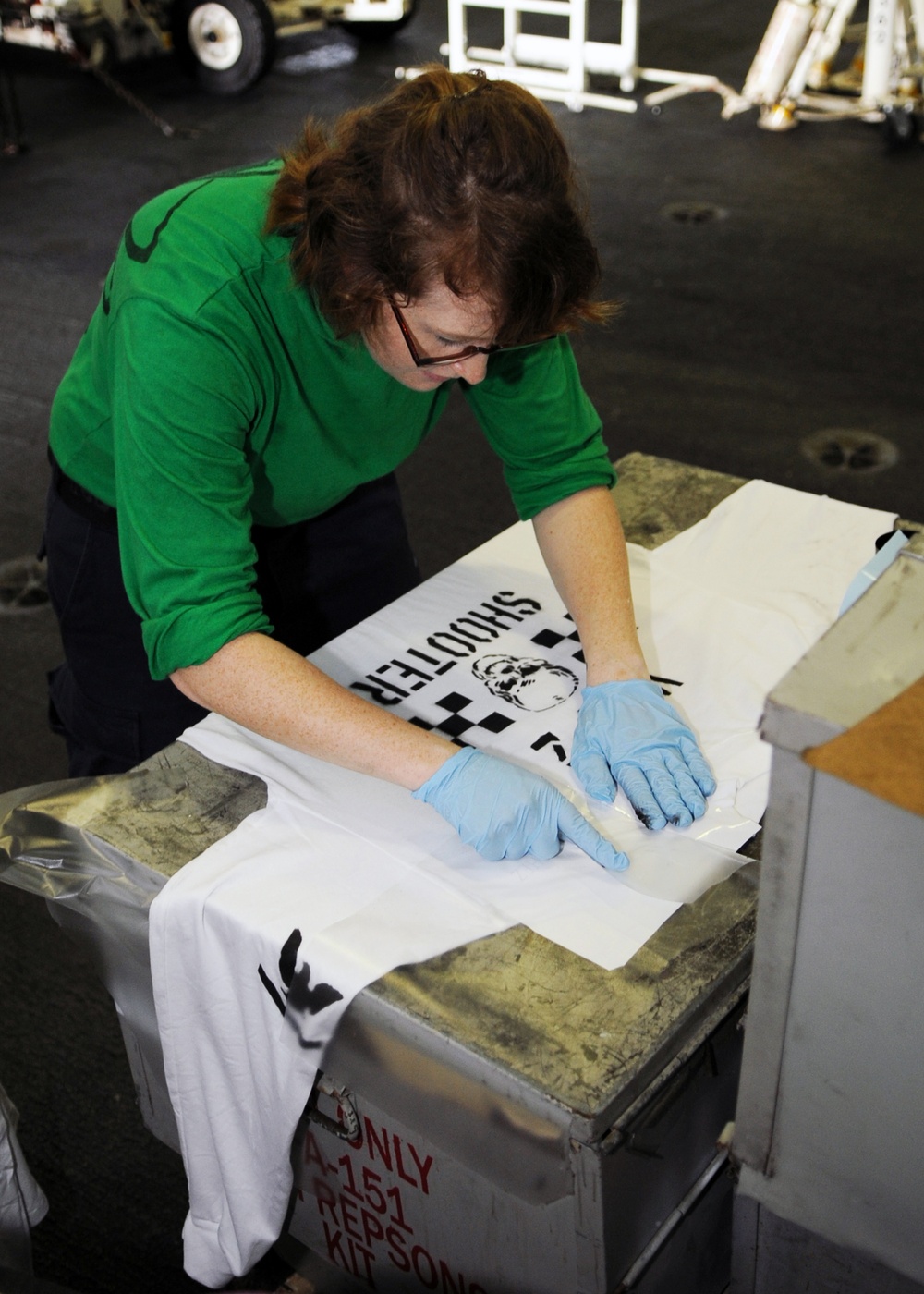 USS Abraham Lincoln sailor paints jerseys