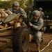 Paratroopers prepare howitzer for firing position