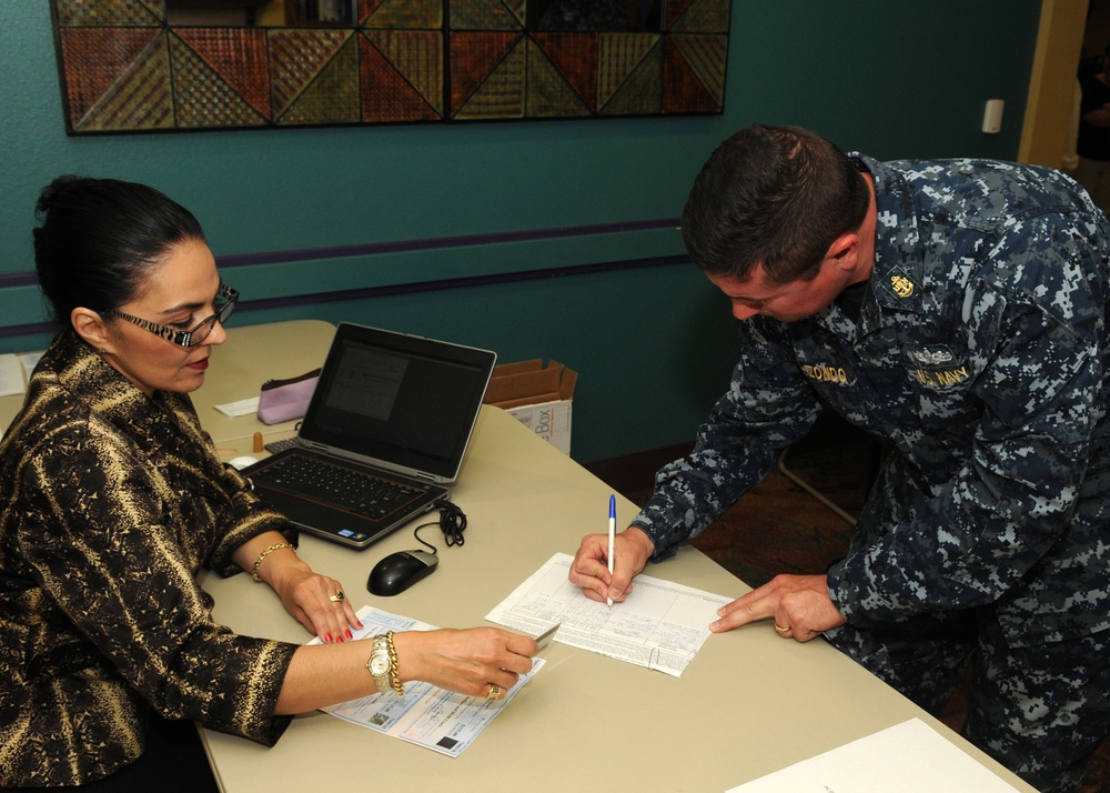 Sailor signs for transportation voucher