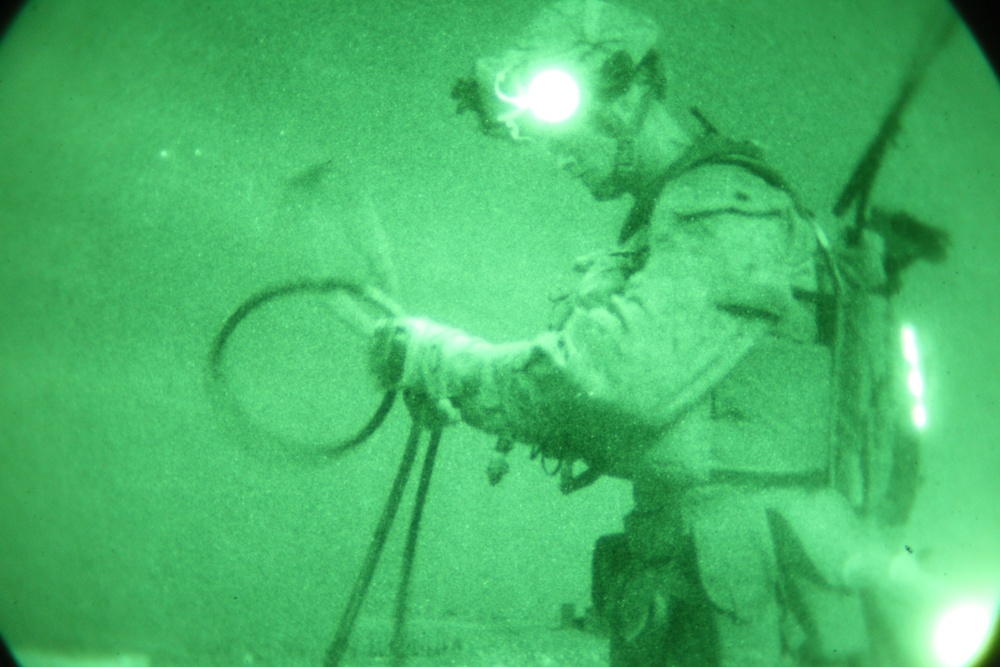 Helicopter Support Team conducts night operations via sling load